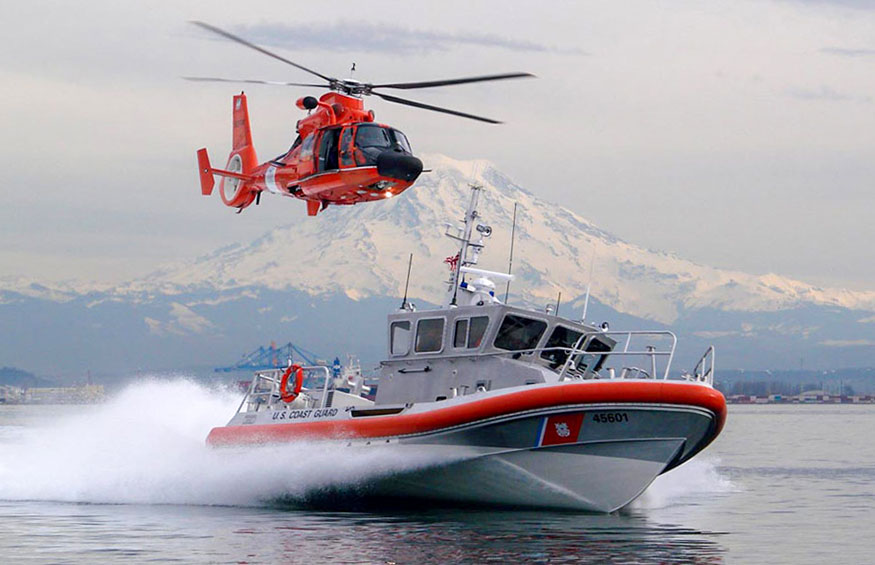 US Coast Guard vessel underway with helicopter